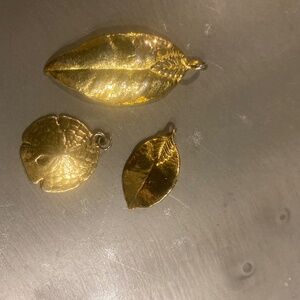 2gold leaves and a sand dollar pendants